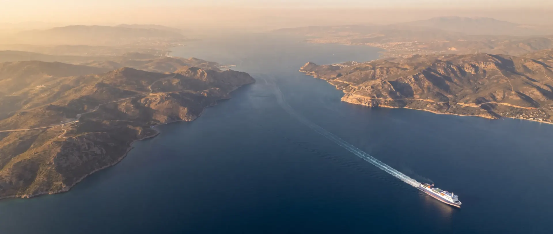 Freight ferry crossing a strait between two coastlines